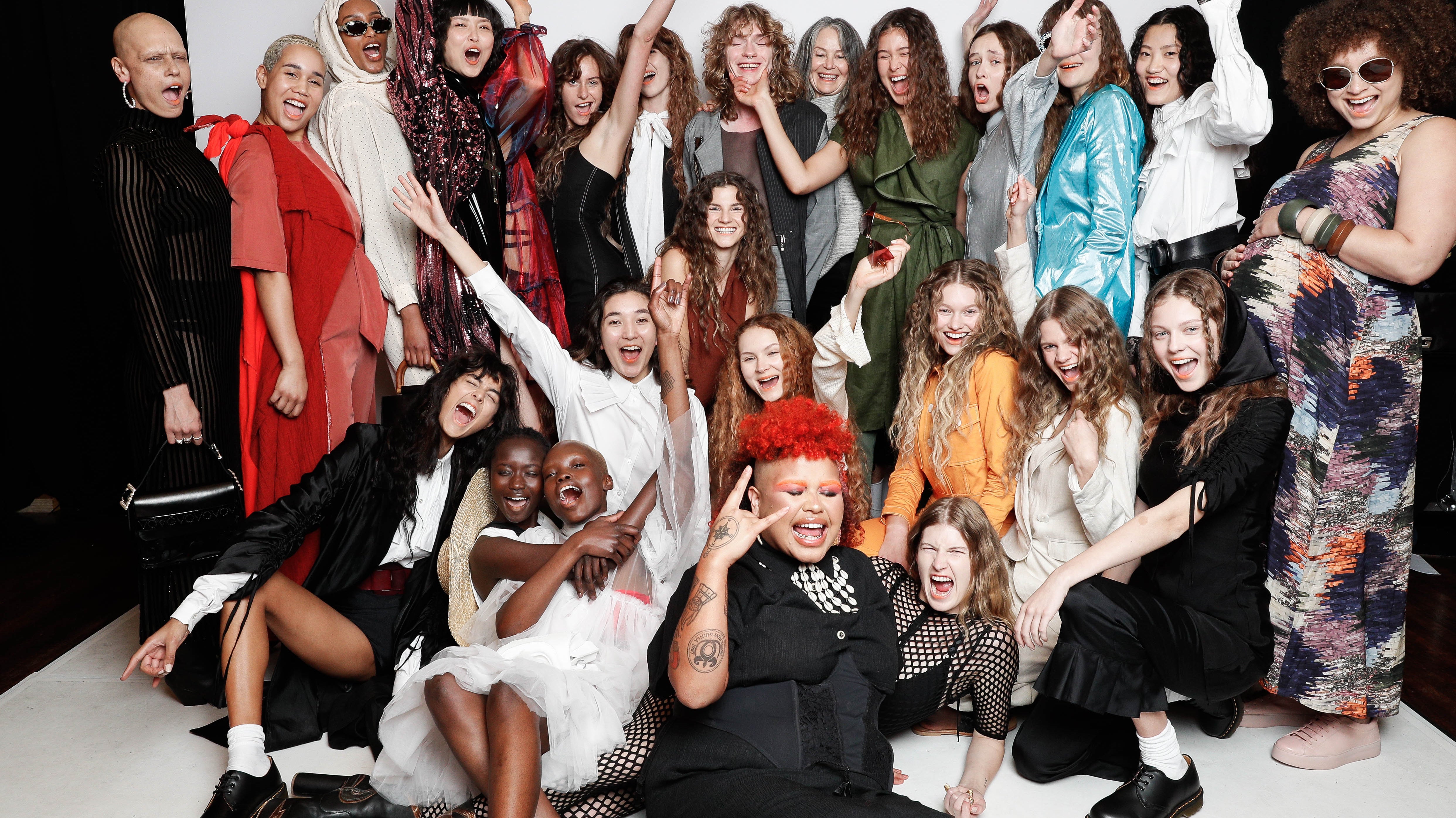 Group photo of runway models and musicians all grouped together