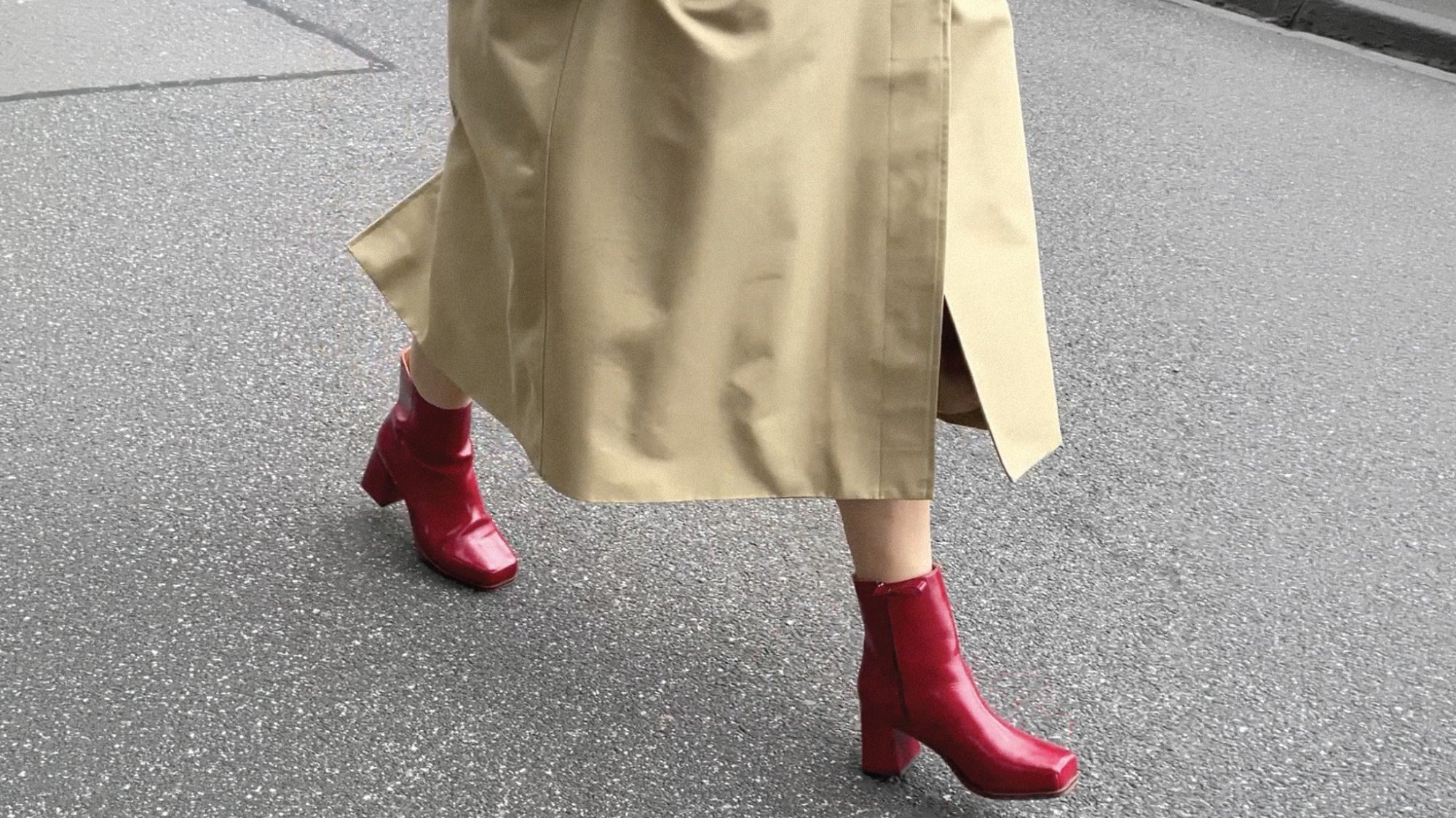 Women walking in red boots with beige trench coat