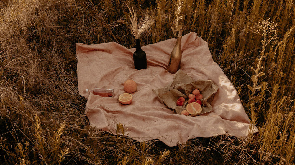 Orange toned picnic display in long dried grass