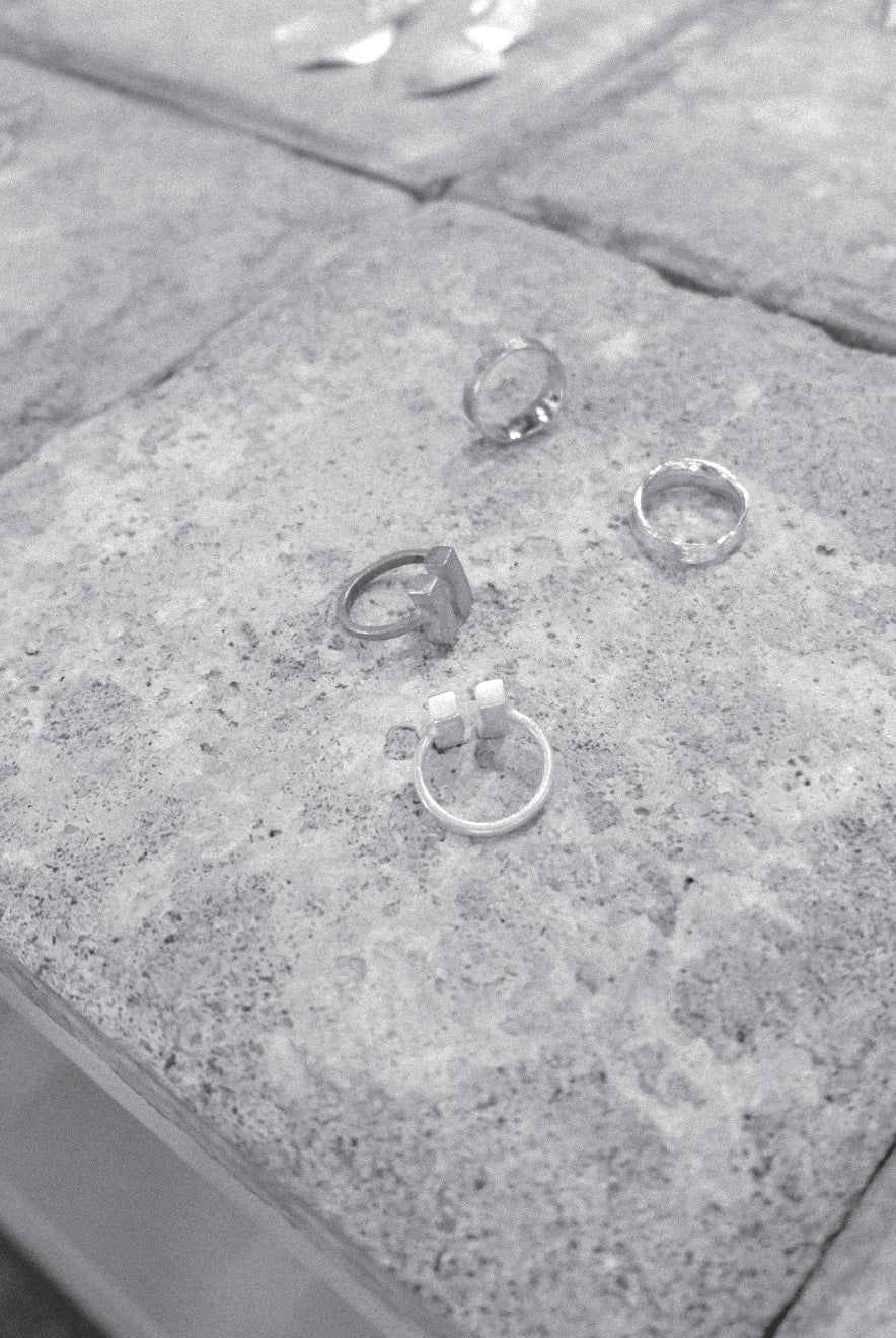 Jewellery pieces on a series of concrete tiles