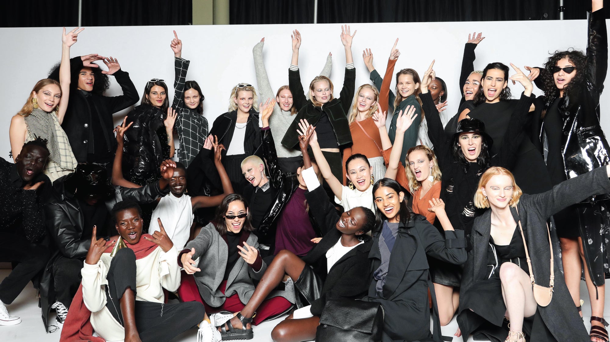 Group photo of runway models and musicians all grouped together