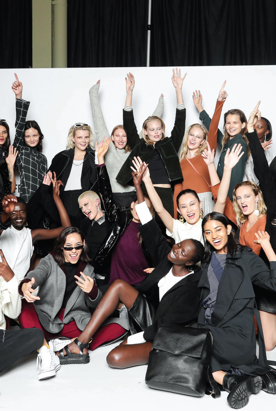 Group photo of runway models and musicians all grouped together