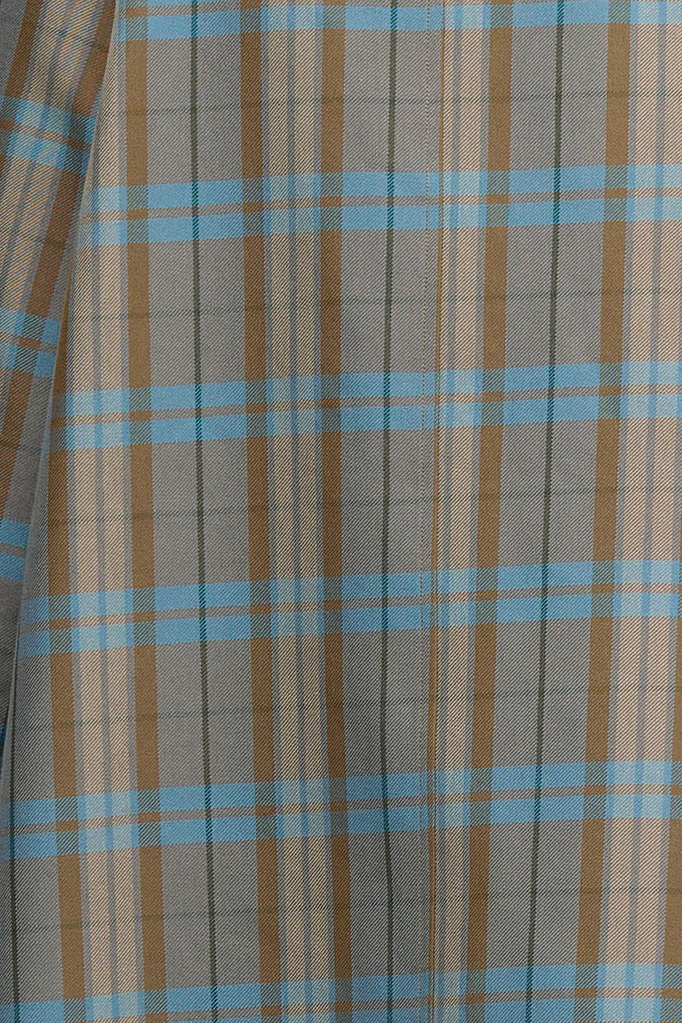 Woman wearing blue and brown check jacket with zipper closure