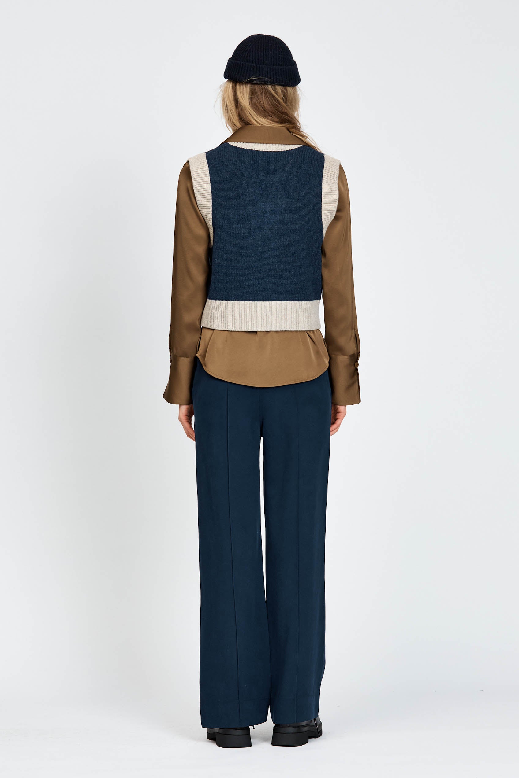 Woman wearing knitted vest in navy