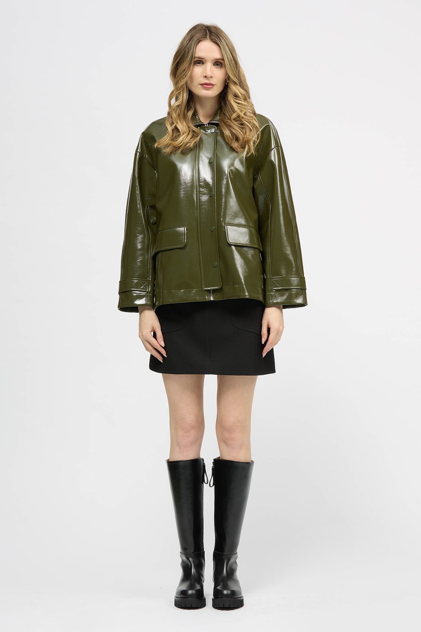 Woman wearing a khaki jacket in high gloss fabric