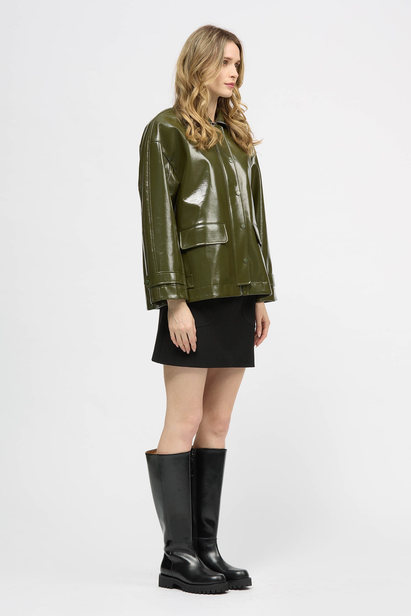 Woman wearing a khaki jacket in high gloss fabric