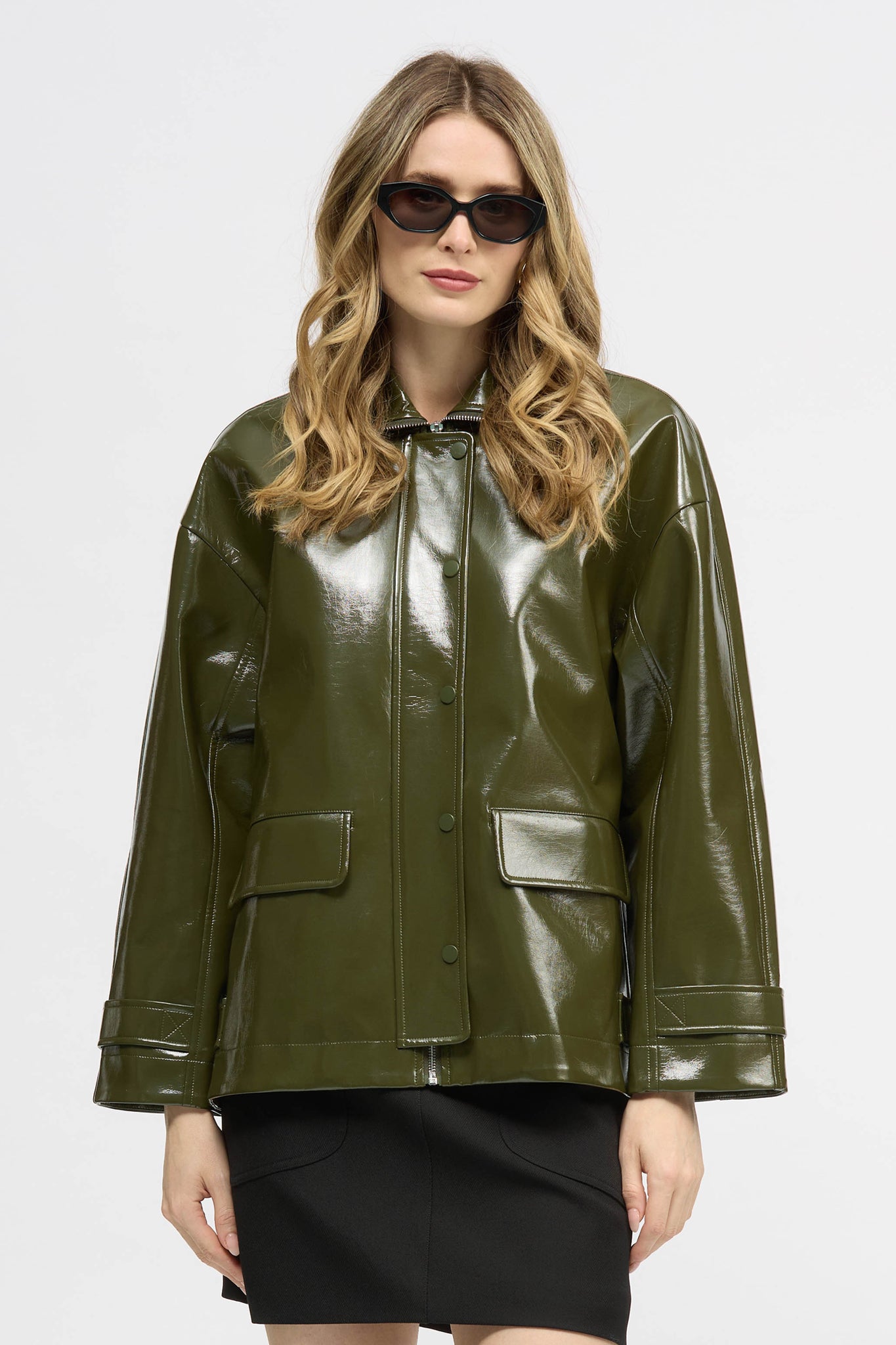 Woman wearing a khaki jacket in high gloss fabric