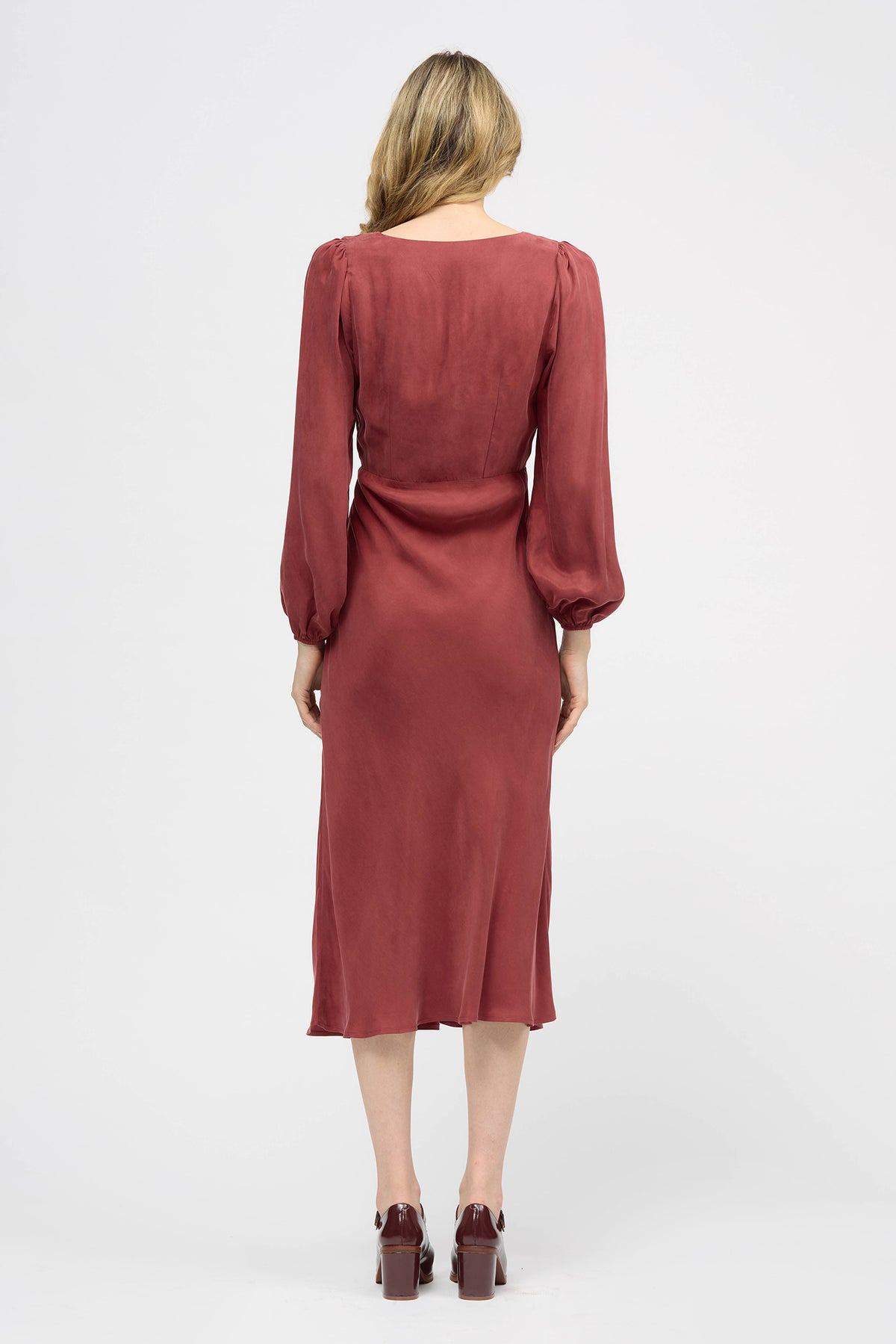 Woman wearing a red long sleeve midi dress