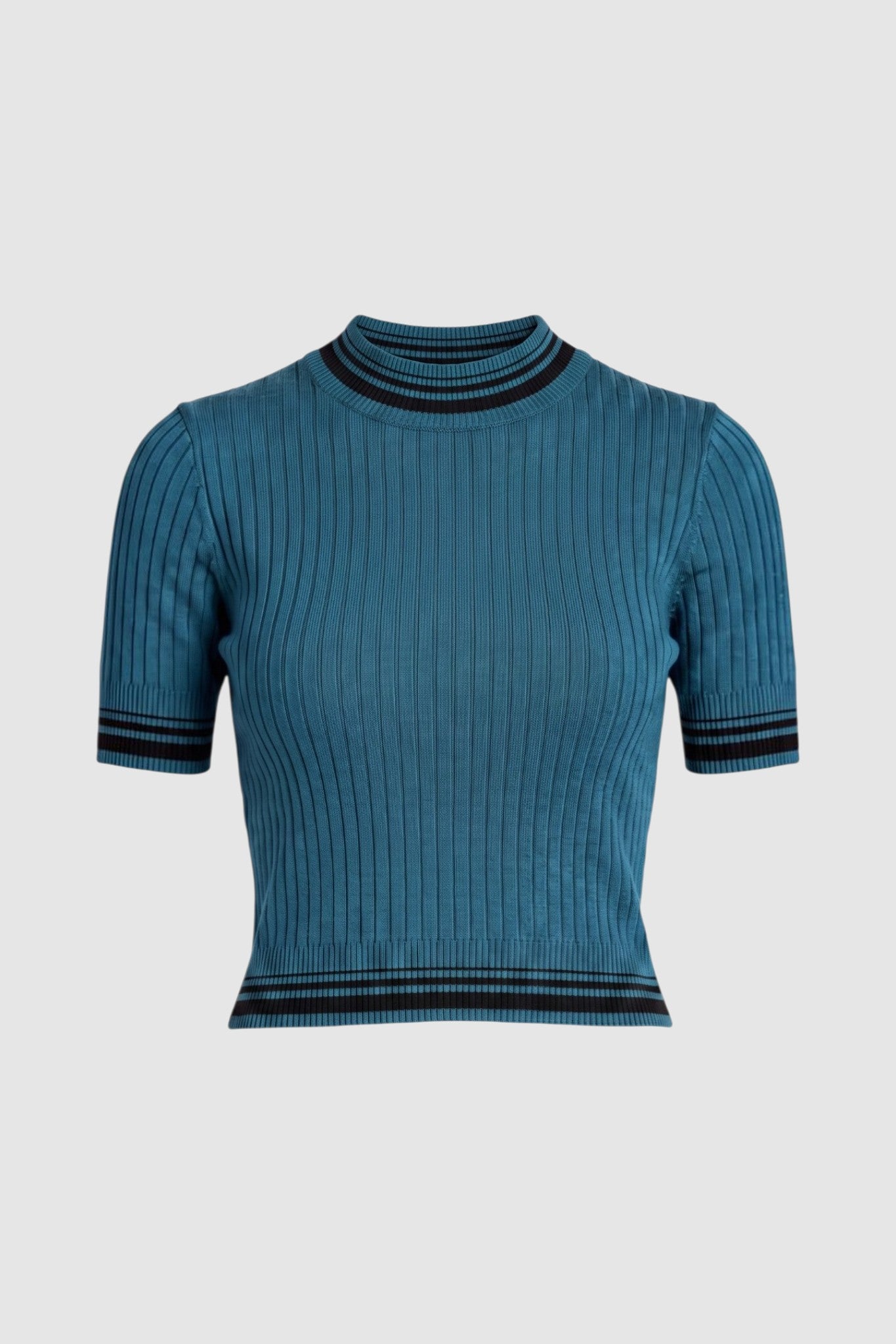 Silo image of a teal short-sleeve ribbed knit mock turtle neck top with black stripes at the collar, sleeve cuffs, and hem, paired with a black skirt, against a light gray studio background.