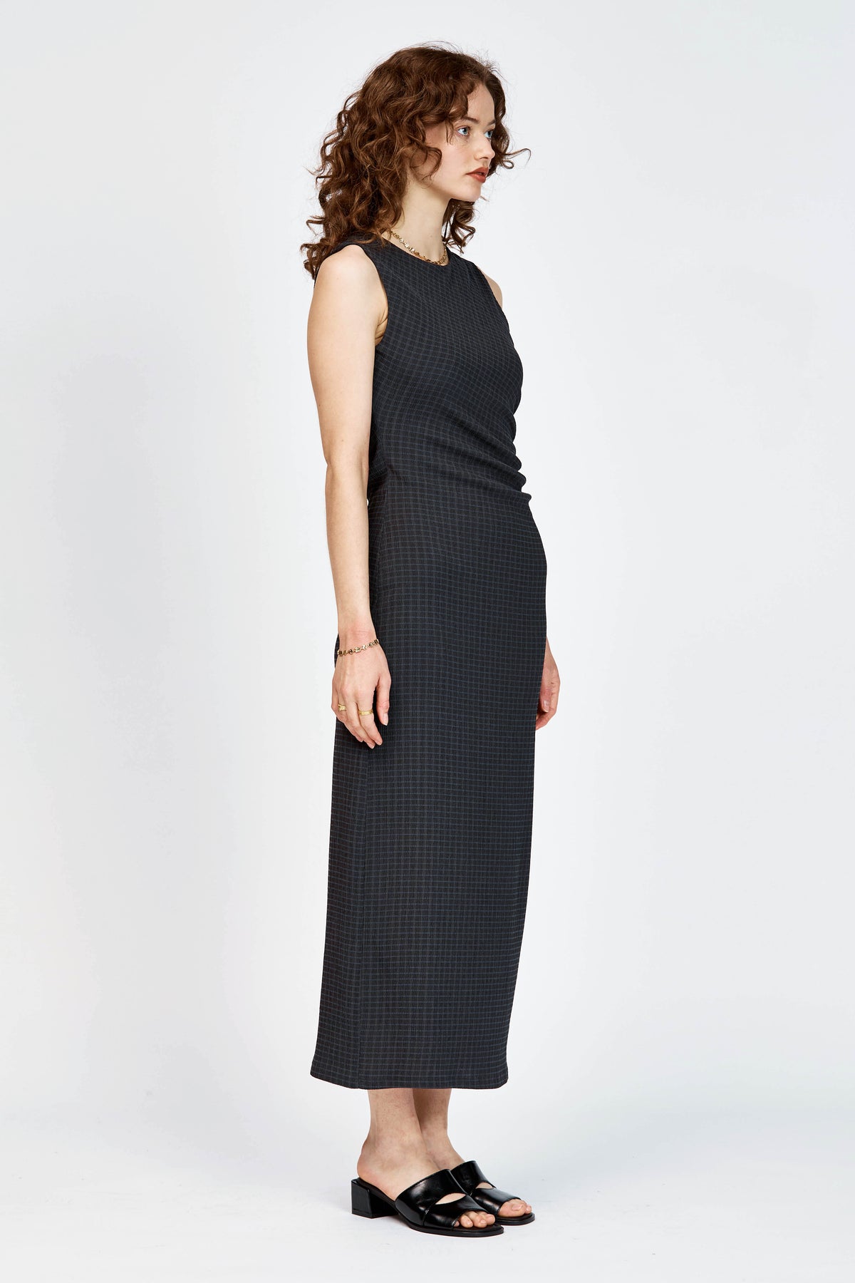 Model wearing black and navy check long dress with waist tie detailing