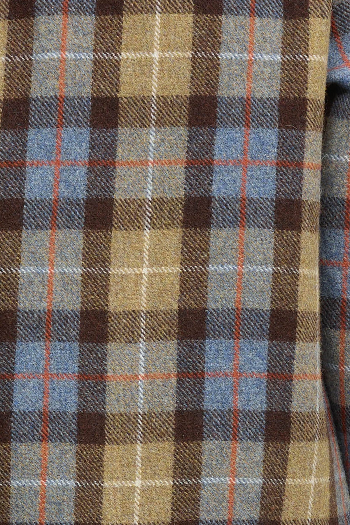 Woman wearing a yellow, brown and blue check jacket