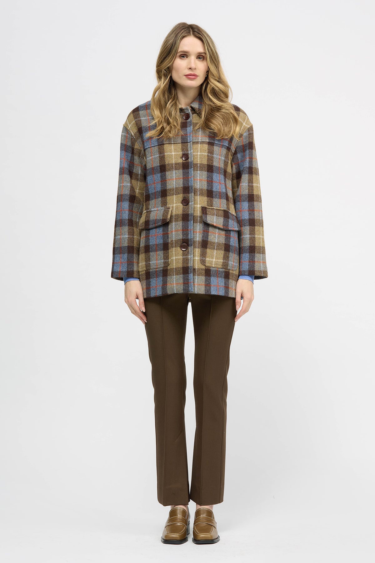 Woman wearing a yellow, brown and blue check jacket