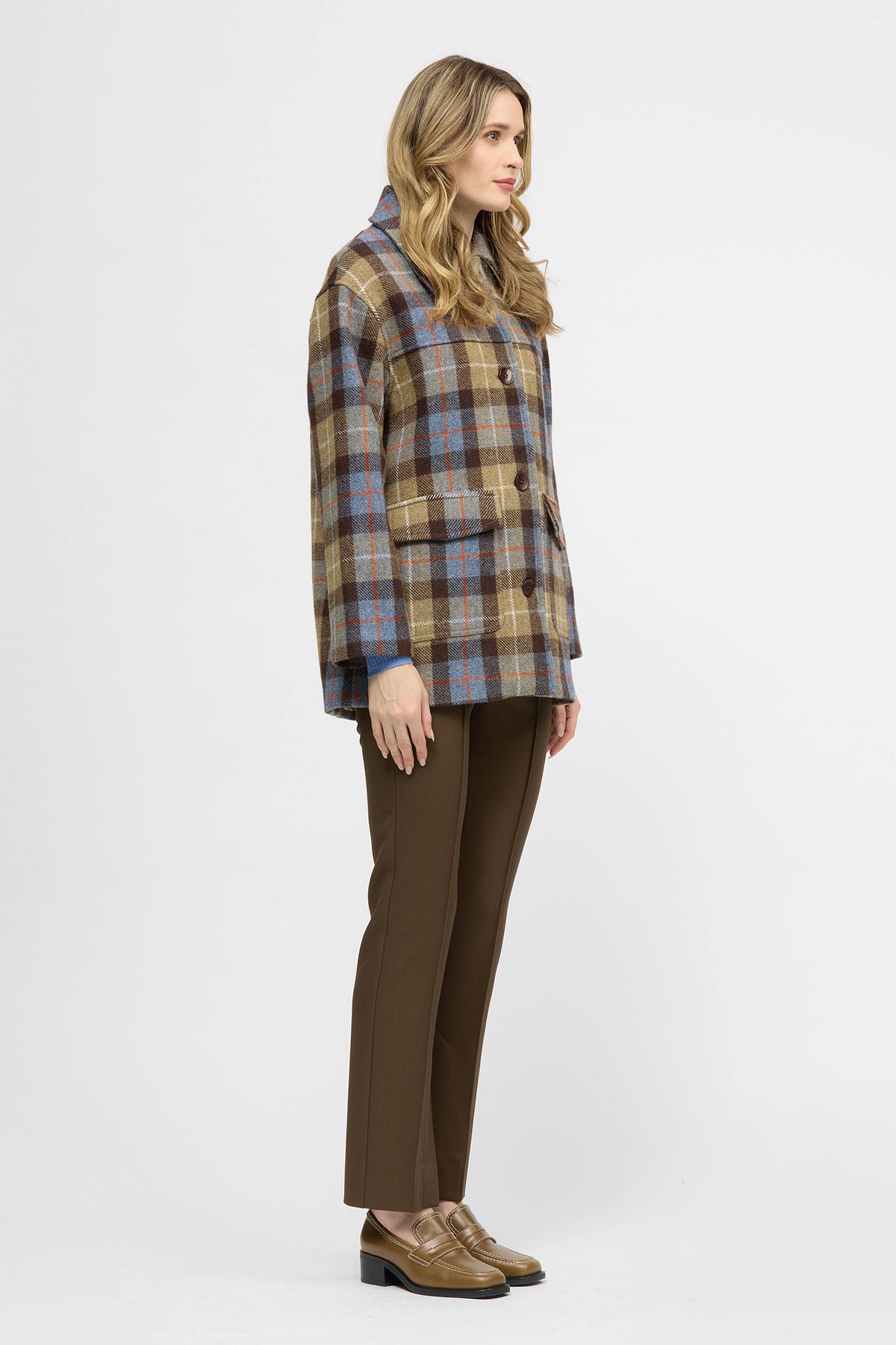 Woman wearing a yellow, brown and blue check jacket