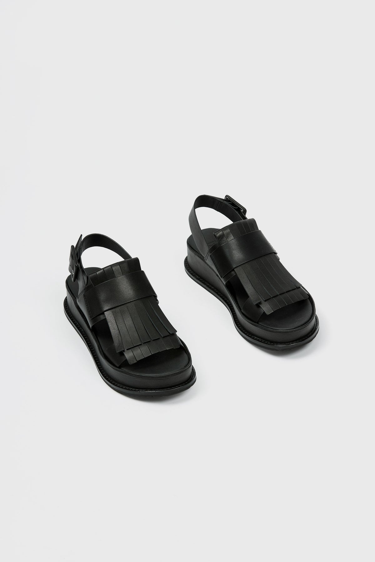 Sandal with fringe detailing and platform sole in black