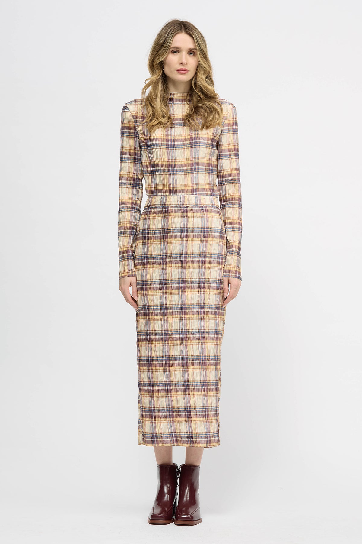 Woman wearing a yellow red and navy check skirt