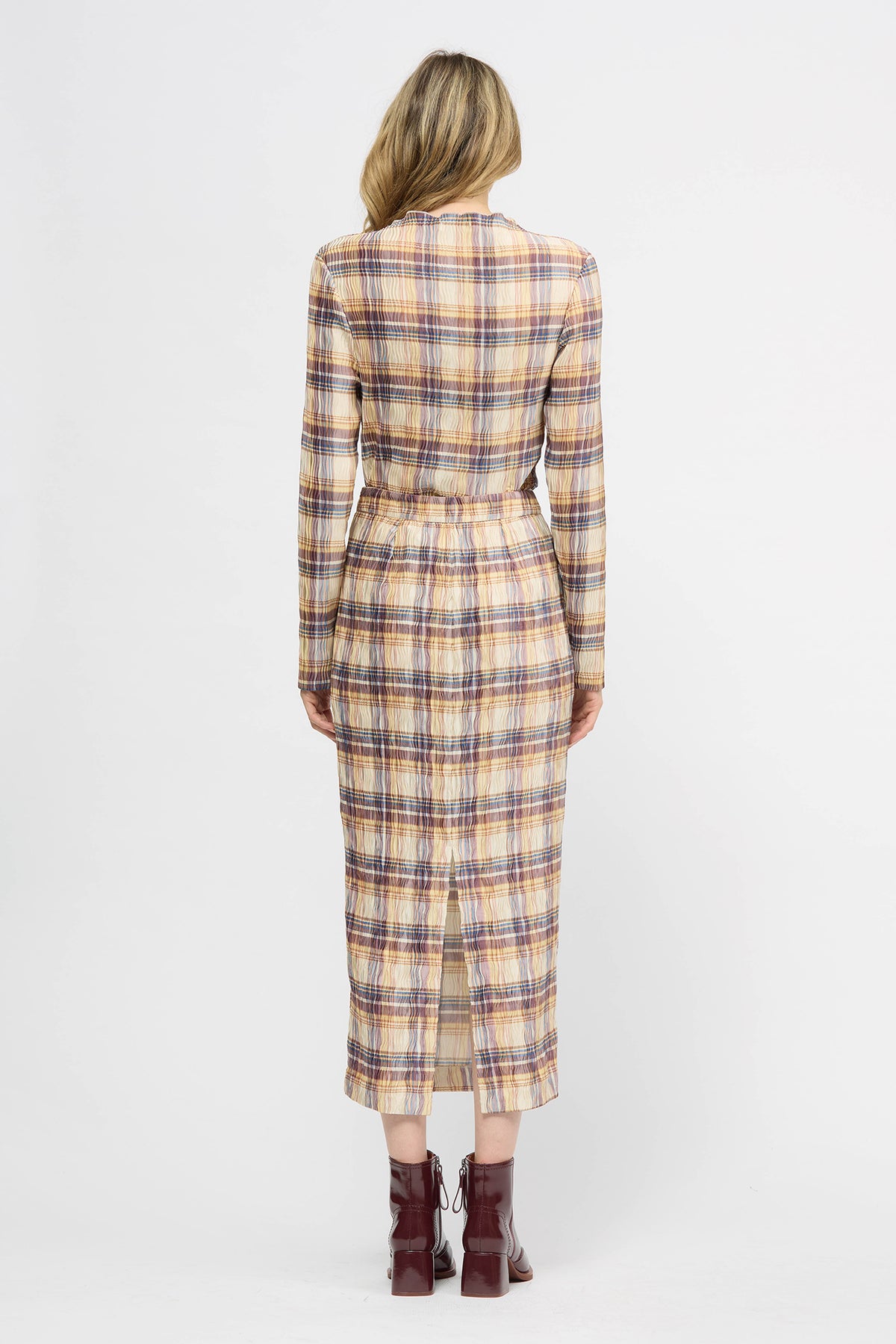 Woman wearing a yellow red and navy check skirt