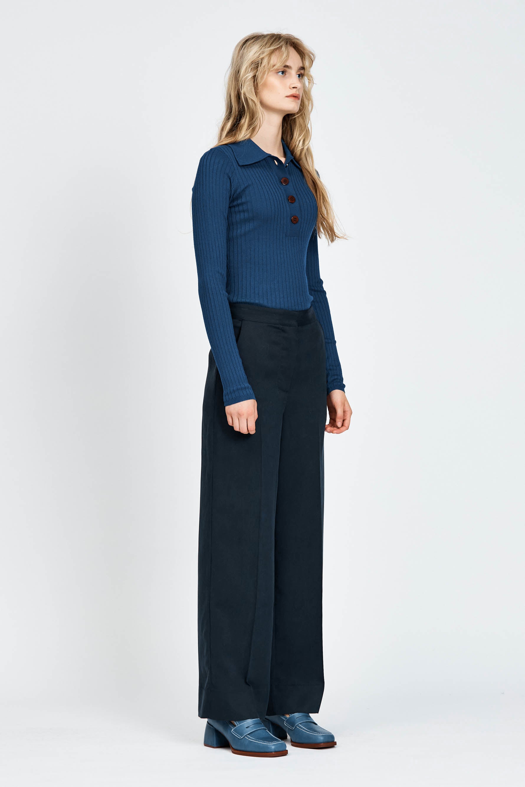Woman wearing blue knitted long sleeve top