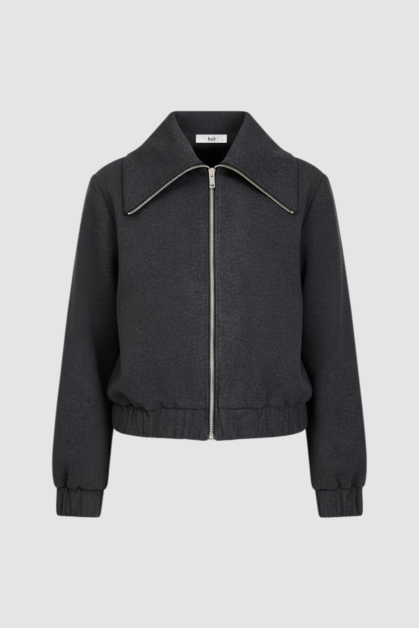 Model wearing a black jacket with zipper