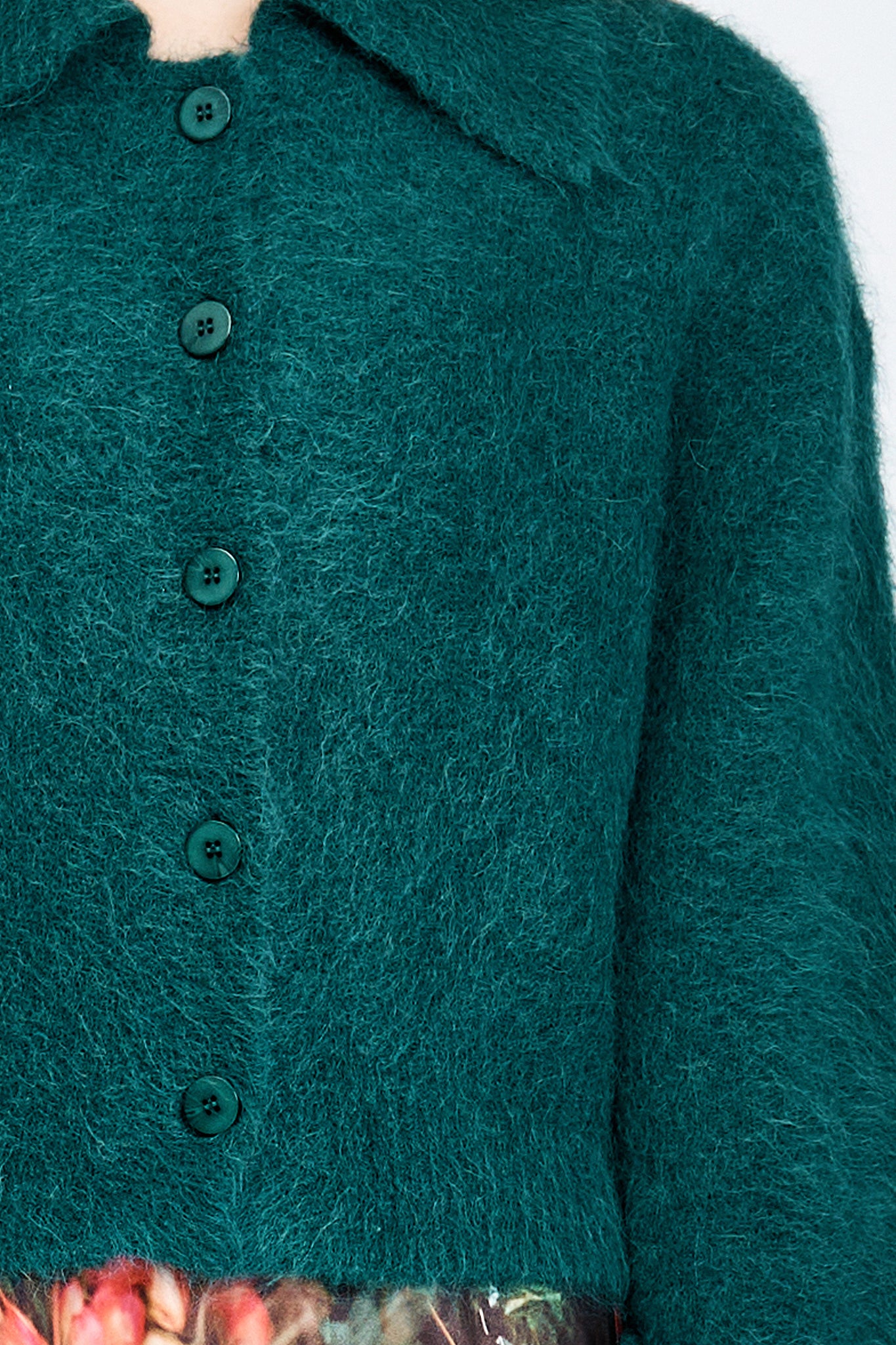 Woman wearing a fluffy green cardigan