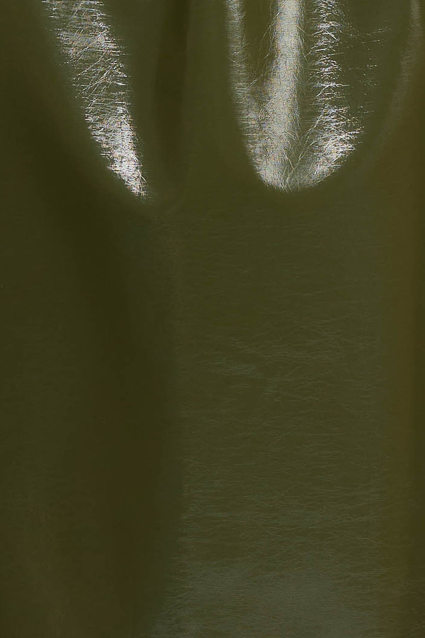 Woman wearing a khaki jacket in high gloss fabric