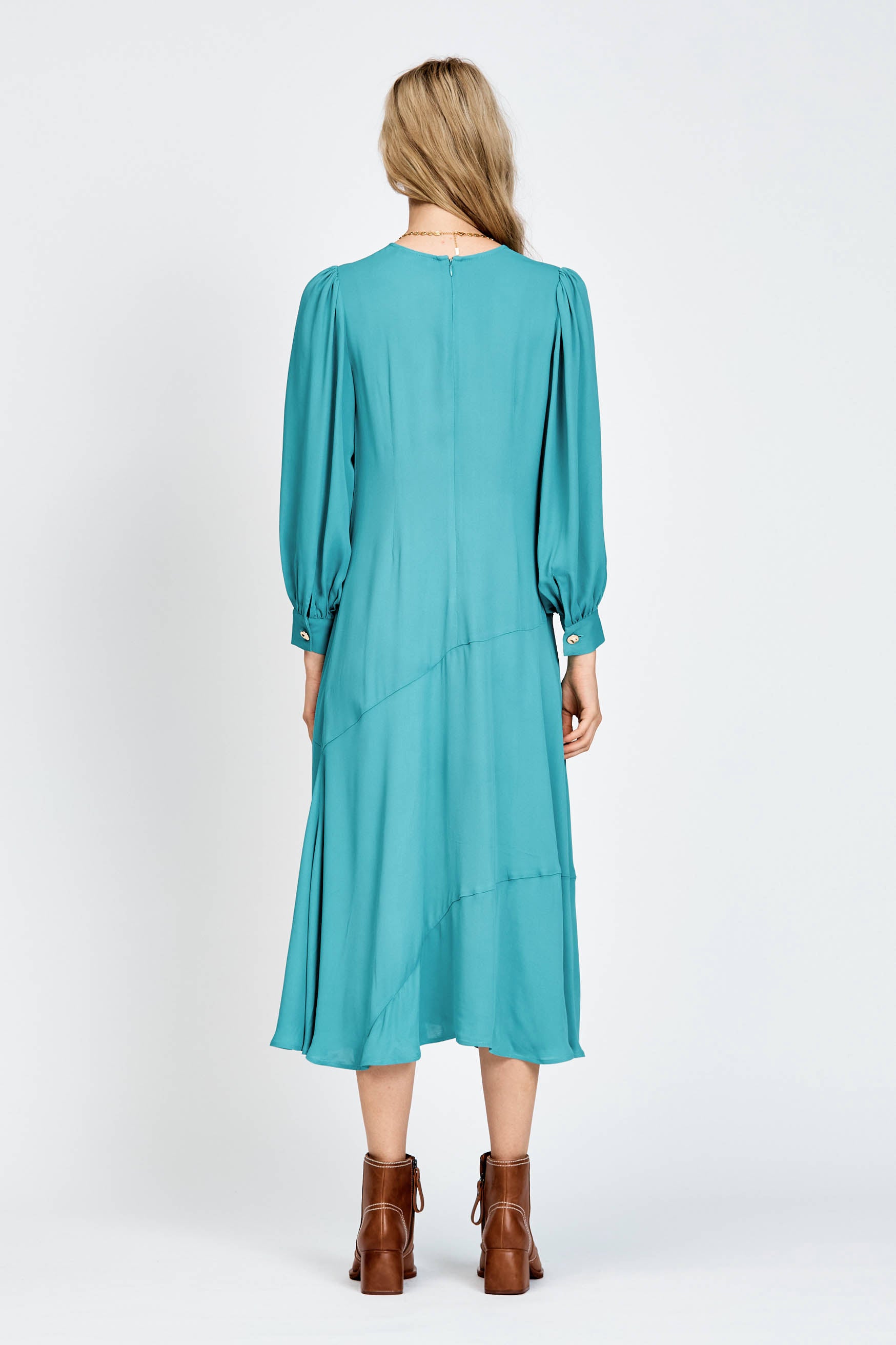 Model wearing a long sleeve green dress