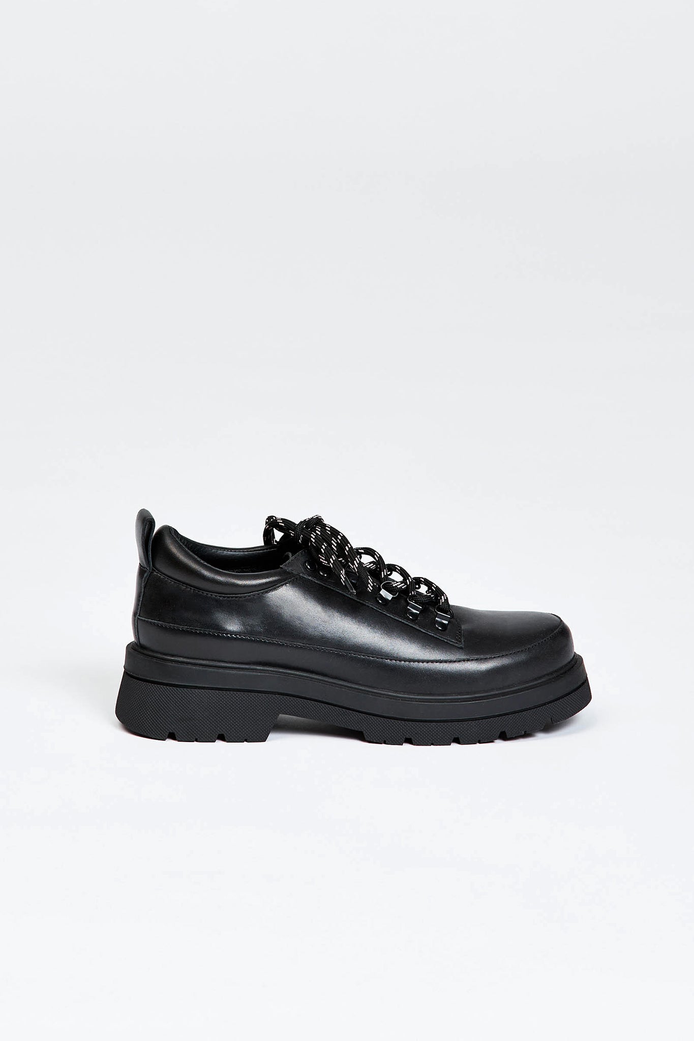 Black shoe with round toe and black and white contrast laces