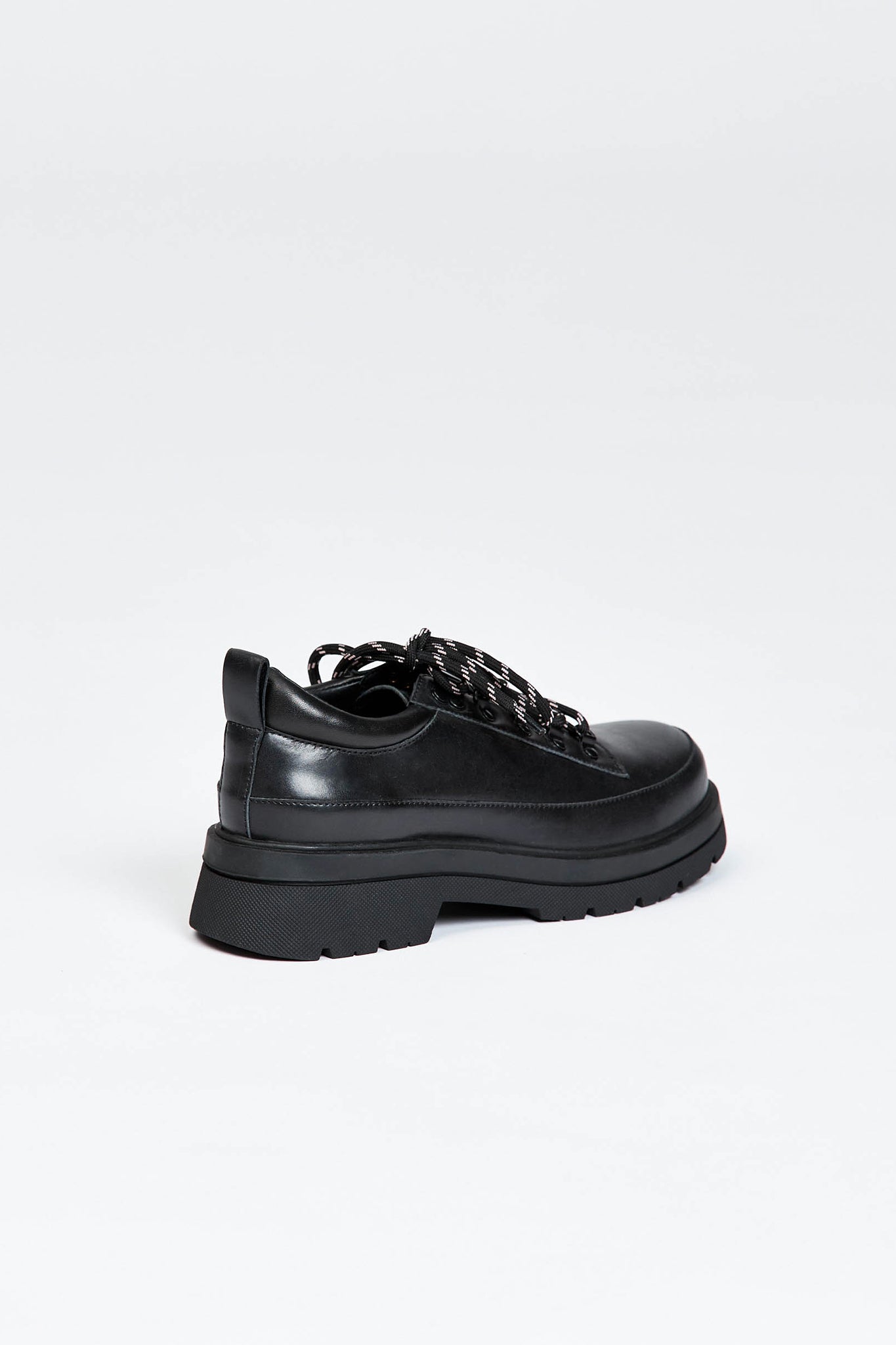 Black shoe with round toe and black and white contrast laces