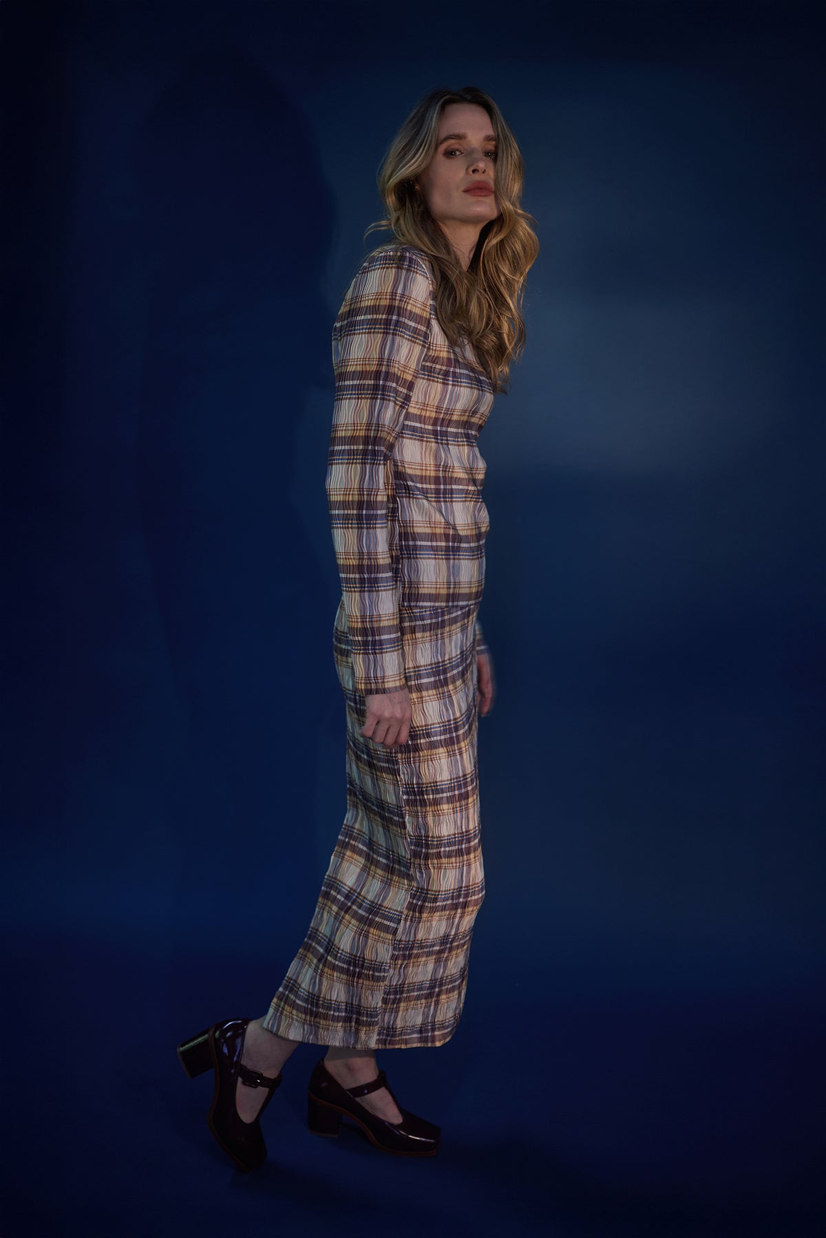 Woman wearing a yellow red and navy check skirt