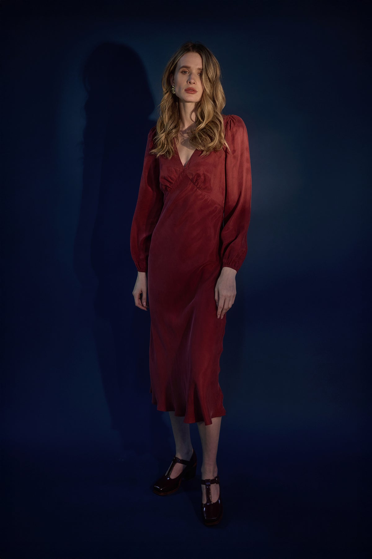 Woman wearing a red long sleeve midi dress
