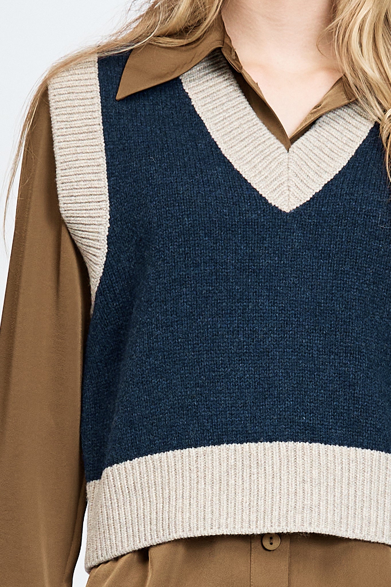 Woman wearing knitted vest in navy
