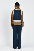 Woman wearing knitted vest in navy