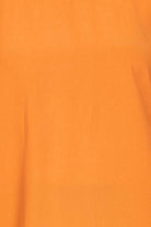 Fabric swatch of the orange top