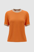 Image of the orange top with stripe detailing along neckline and armholes