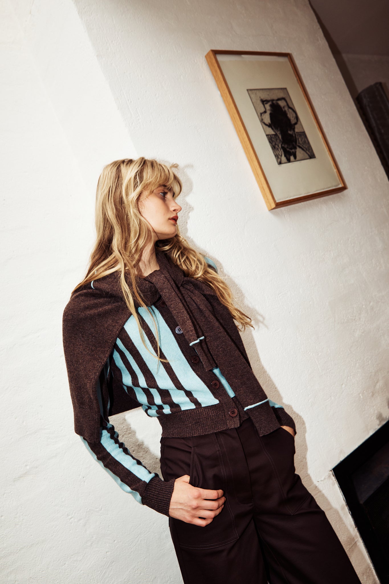 Woman wearing a woollen cardigan with brown and blue stripes