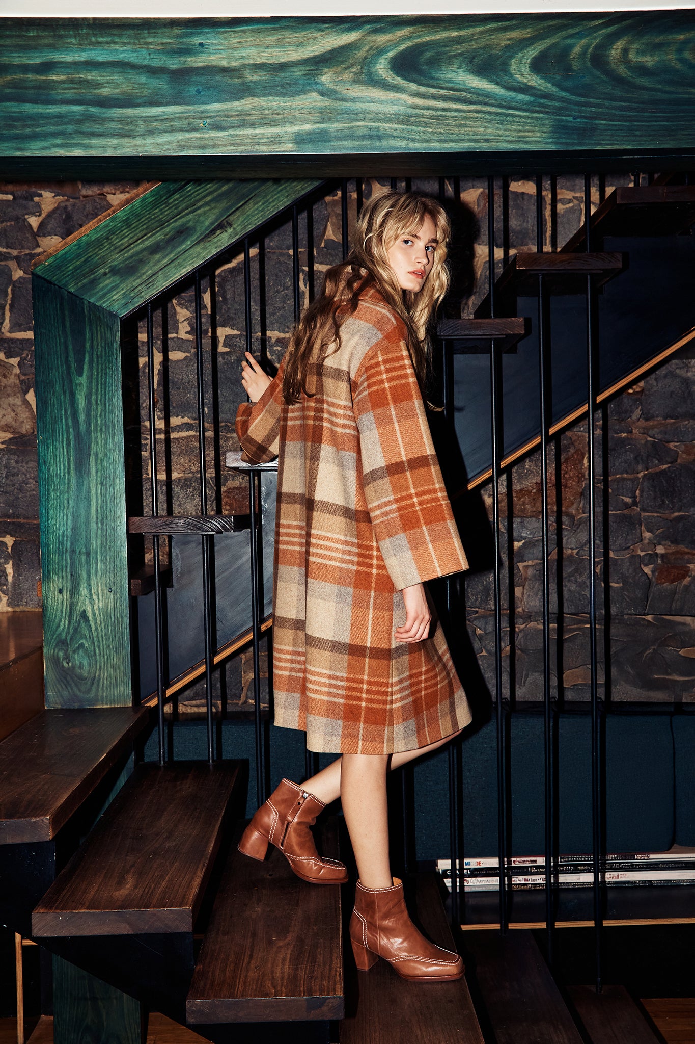 Model wearing a brown check woollen coat