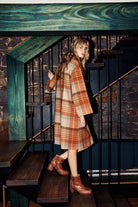 Model wearing a brown check woollen coat