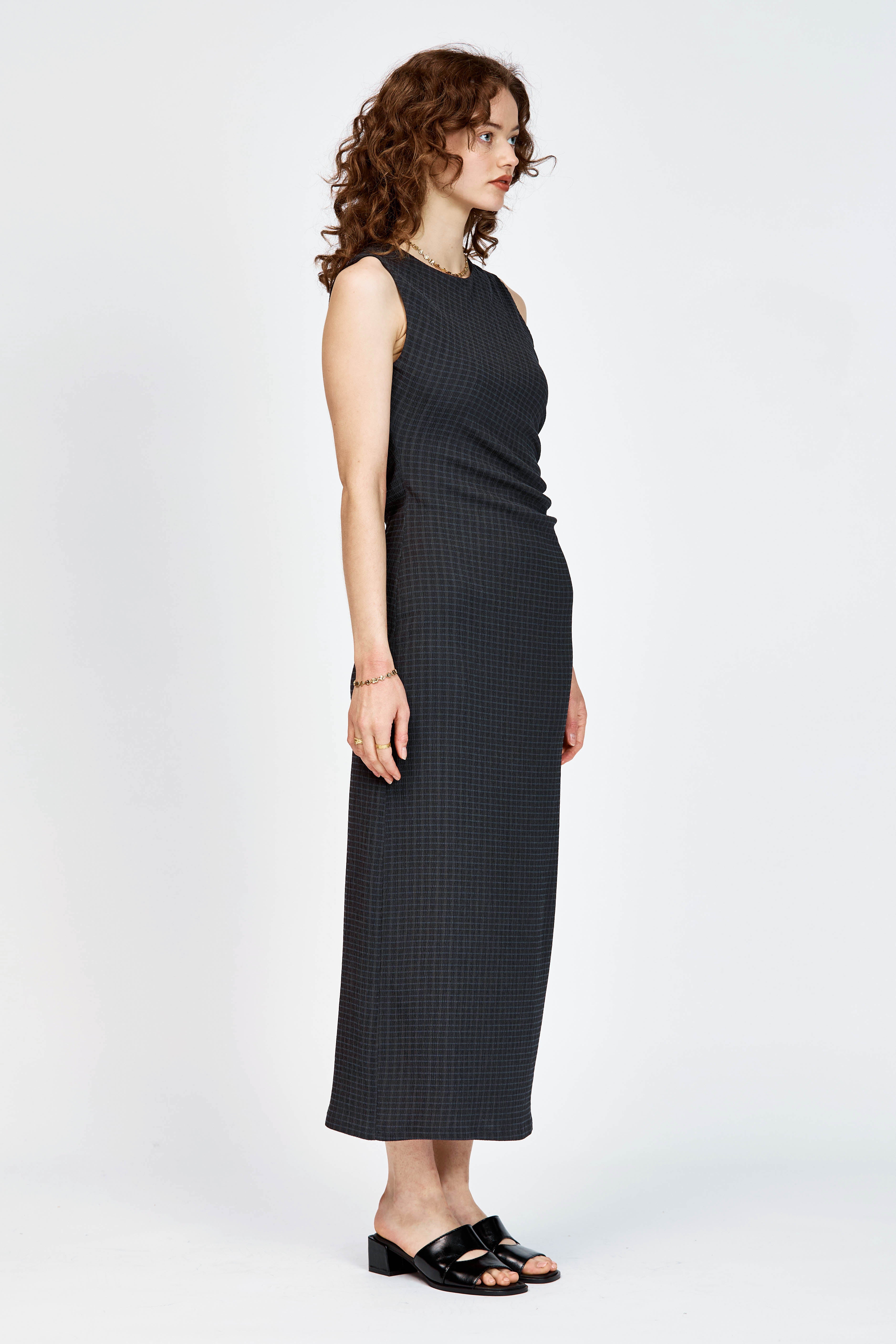 Model wearing black and navy check long dress with waist tie detailing