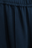 Model wearing a navy long pant in relaxed silhouette