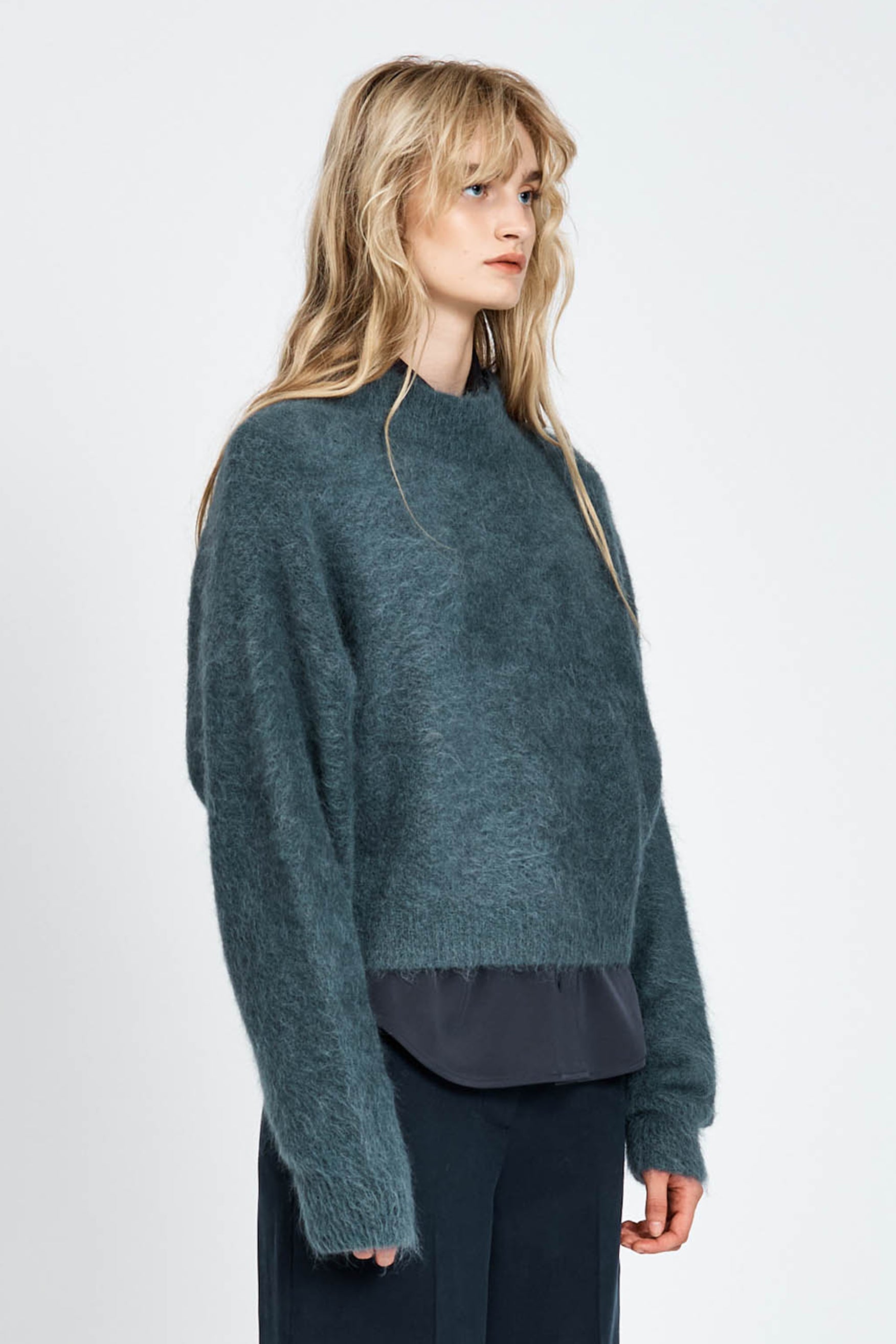 Woman wearing woollen jumper in blue