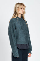 Woman wearing woollen jumper in blue