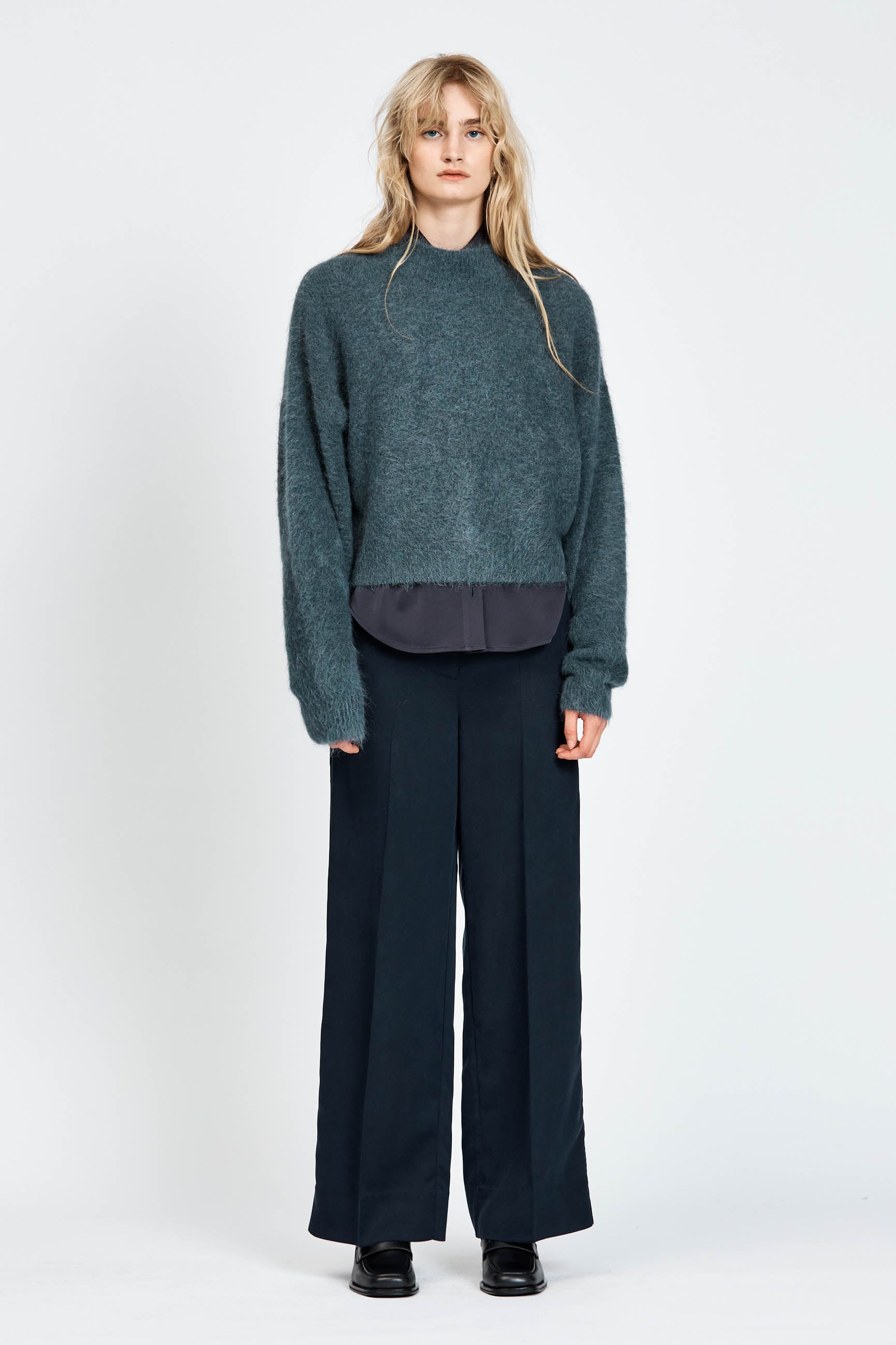 Woman wearing woollen jumper in blue