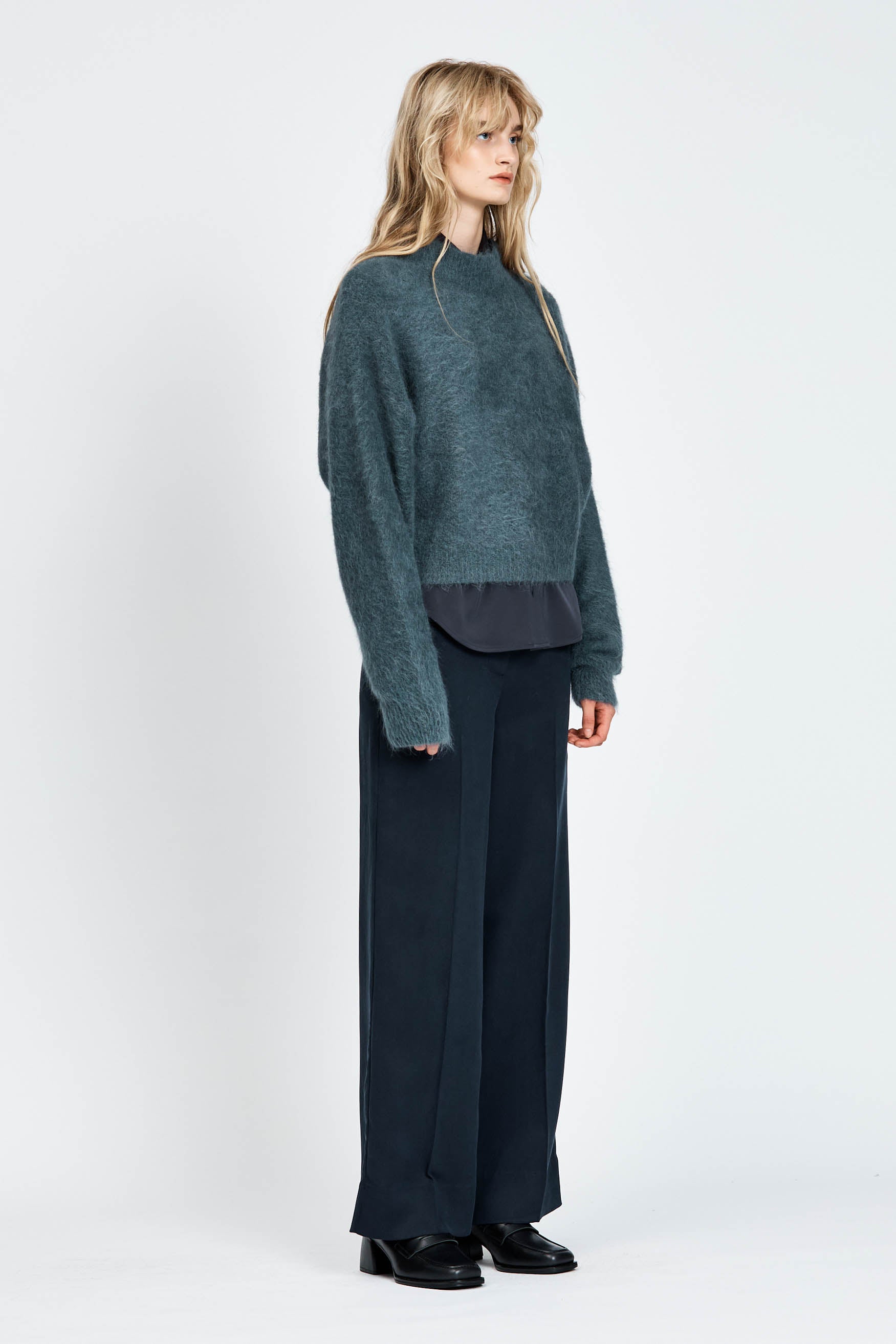 Woman wearing woollen jumper in blue
