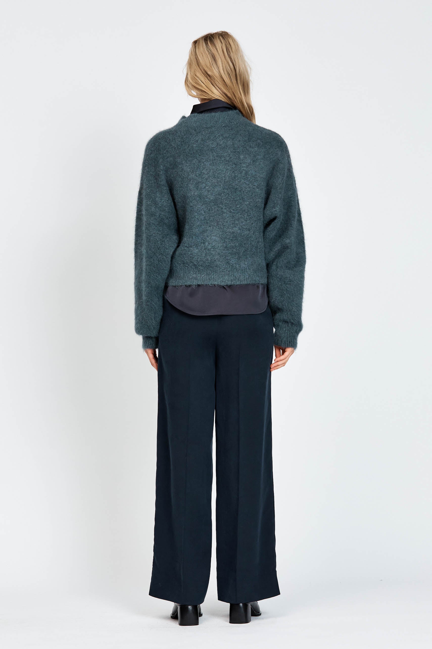 Woman wearing woollen jumper in blue