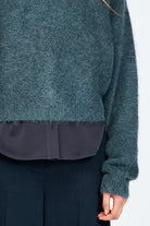 Woman wearing woollen jumper in blue
