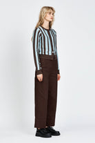 Woman wearing a woollen cardigan with brown and blue stripes