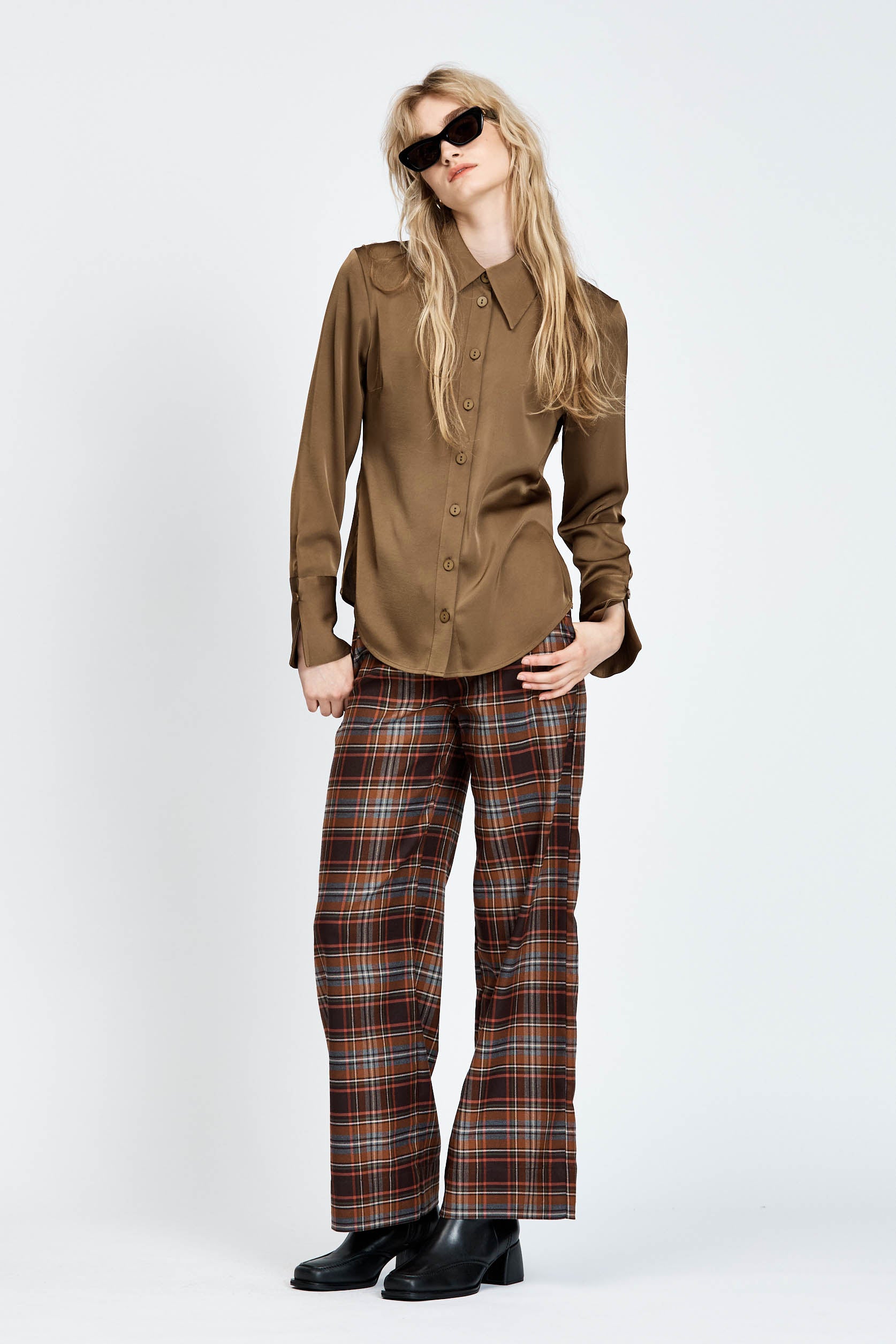 Model wearing a pair of brown check pants