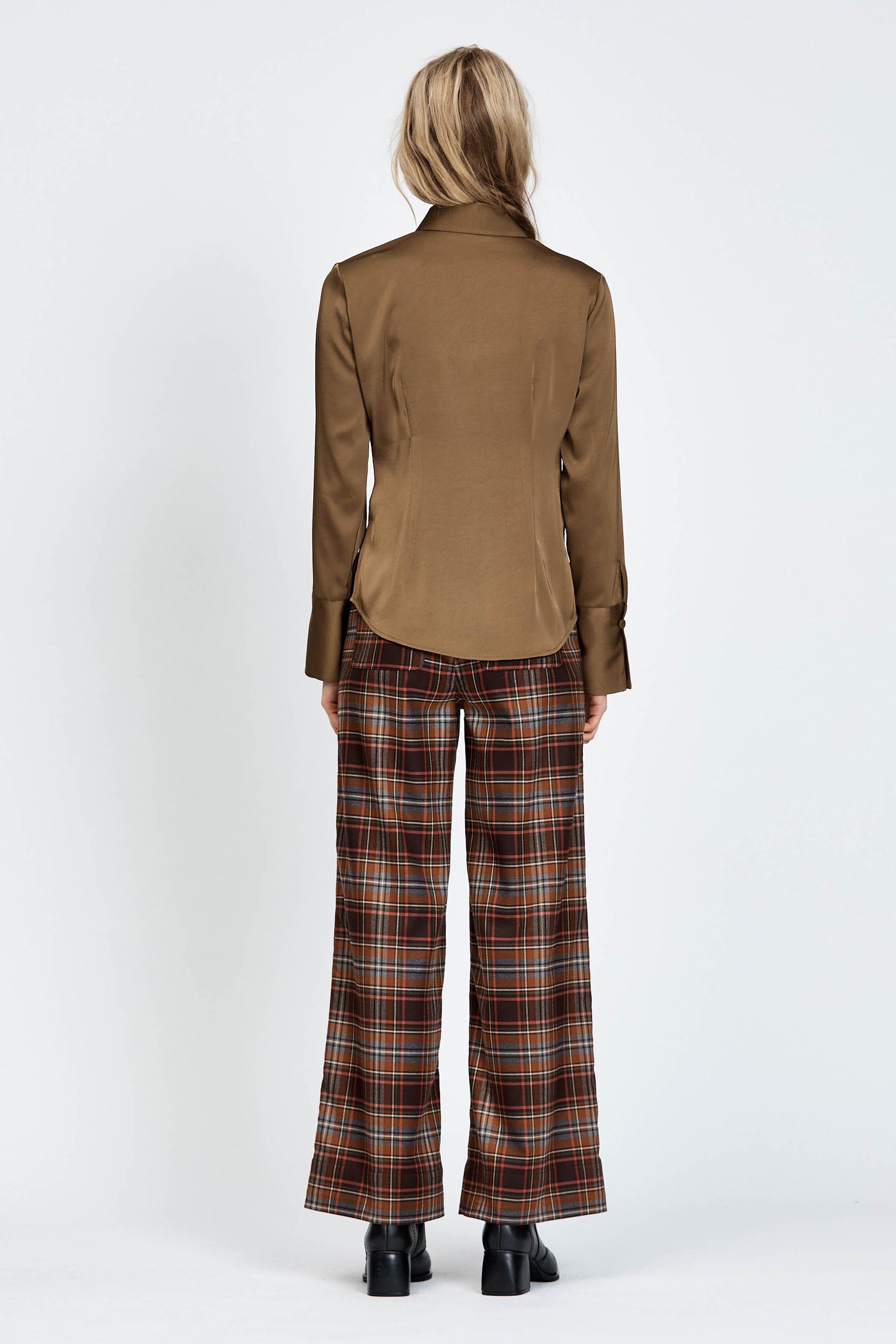 Model wearing a pair of brown check pants