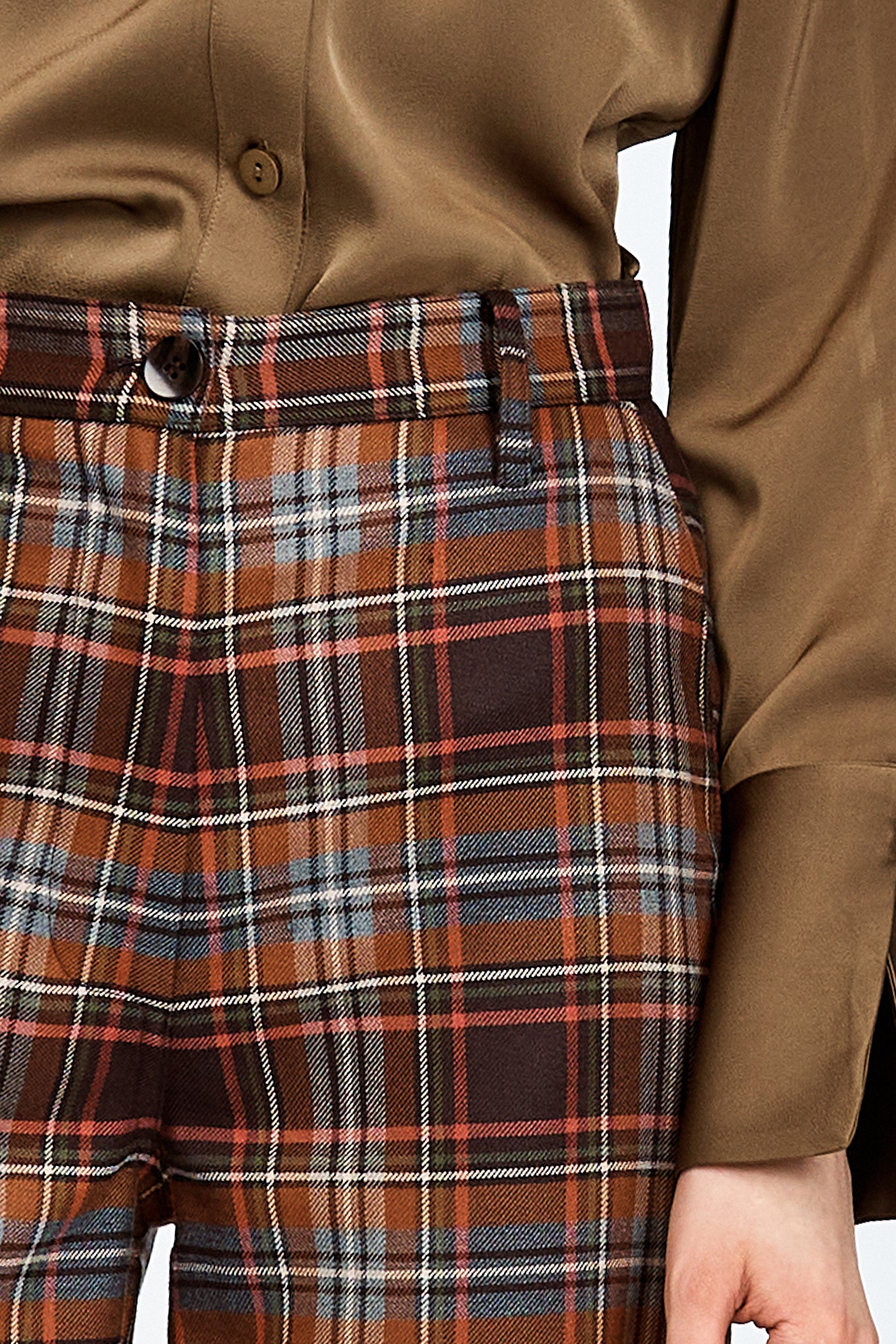 Model wearing a pair of brown check pants