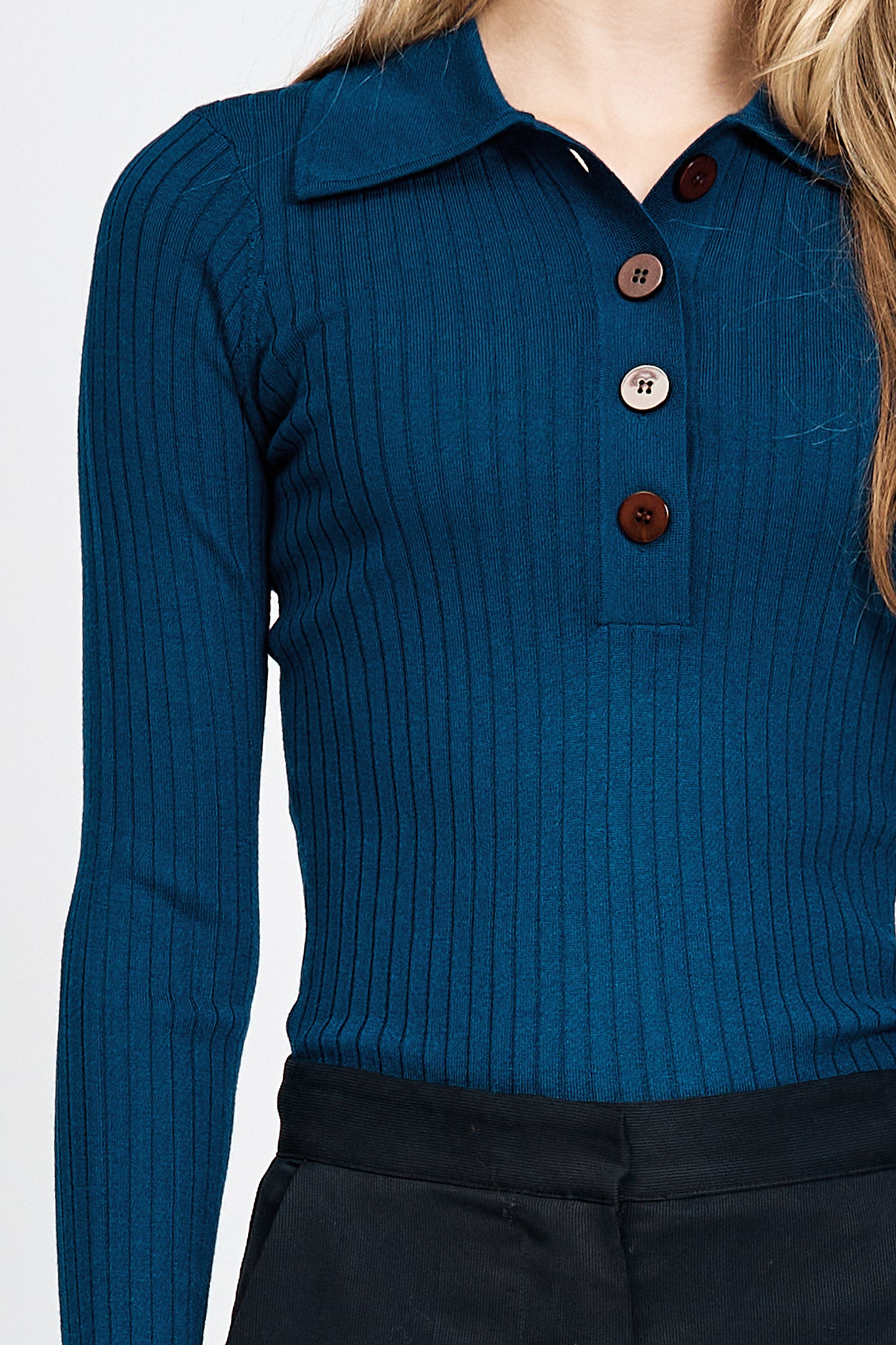 Woman wearing blue knitted long sleeve top