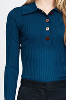 Woman wearing blue knitted long sleeve top